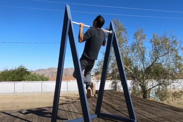 man doing pull-up using homemade outdoor pull-up bar