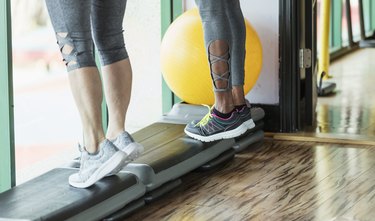 Women performing deficit calf raises.