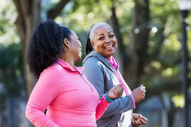 Two women walking at average speed outside and talking