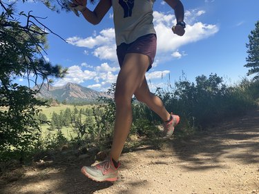 photo of lower half of woman running on an outdoor trail