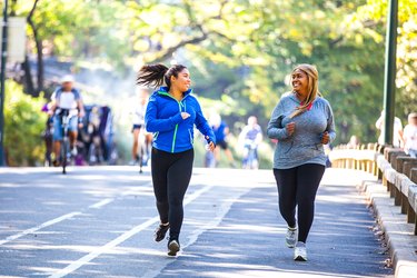 Two younger women jogging outdoors