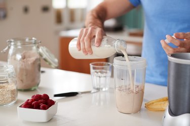 Person in kitchen making sports nutrition shake