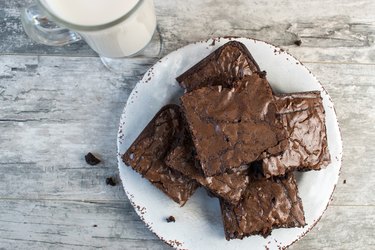 Chocolate brownies on white plate with milk