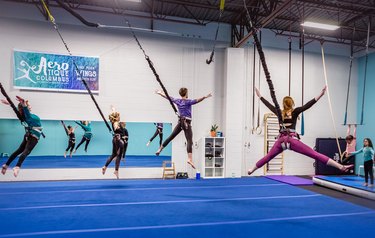 group of people in a gymnasium doing a bungee workout