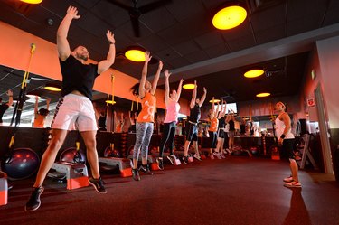 group of people participating in an Orangetheory Fitness workout class