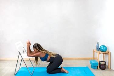 woman doing a kneeling lat stretch