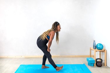 woman doing a standing hamstring stretch