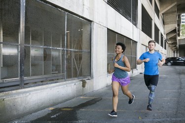Couple going for a run outside wearing running clothing