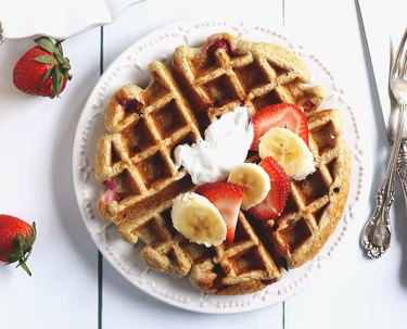 Greek yogurt Belgian waffle topped with cream, bananas and berries.