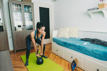 woman using kettlebell for home workout