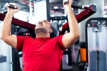 man in gym doing bicep exercises