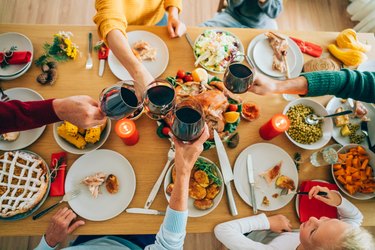 Family clinking glasses at Christmas dinner