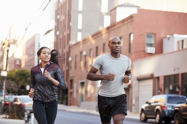 Young couple jogging in Brooklyn street, close up