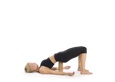 Passive bridge pose Setu Bandha Sarvangasana with yoga block