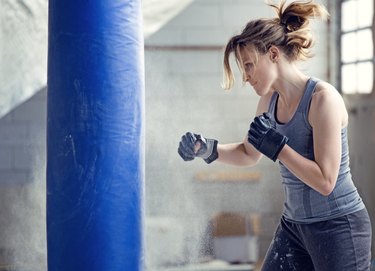 Female boxer in an abandoned warehouse