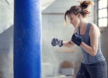 Person boxing using a freestanding punching bag.