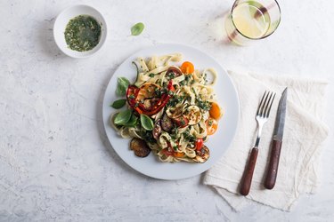 Fettucine with roasted  colorful vegetables and parsley  pesto