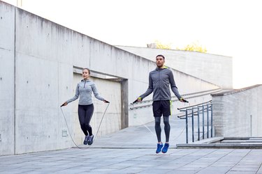 man and woman exercising with jump-rope outdoors