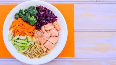 Fresh Healthy Salmon Poke Bowl With Broccoli, Carrots, Wholegrain Rice is what you can eat on the TLC diet