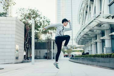 Man jumping outside as part of plyo workout