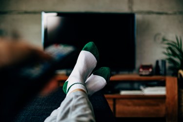 Personal perspective of a woman watching television in a living room