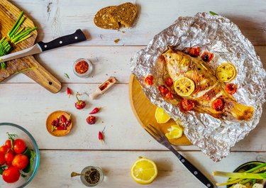 Table setting  with different dishes and grilled fish