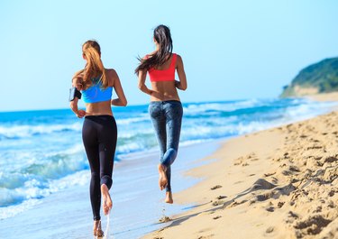 Two young women jogging on coastline