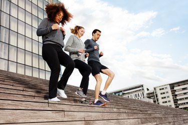 Sporty people running downstairs on city stairs