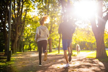 Couple exercising in park.