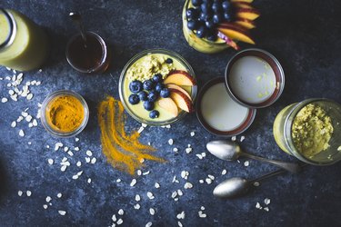 Healthy golden milk overnight oats for breakfast with fresh fruits {gluten-free)