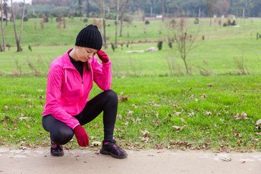 Young woman athlete feeling lightheaded or with headache