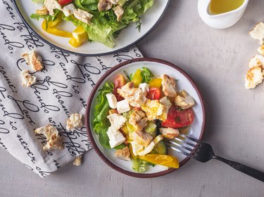 salad ingredients bowl with chicken, greens and veggies