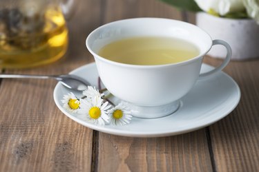 Herbal tea in a white cup with a saucer.