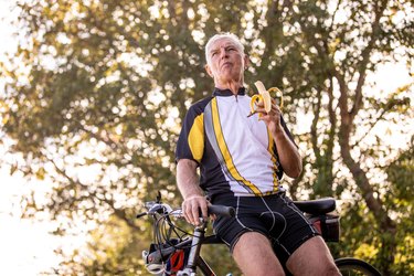 Senior Cross-country Cyclist Eating a Banana