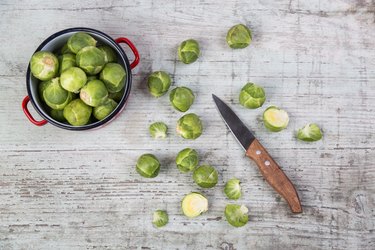 Brussels sprouts, kitchen knife and cooking pot
