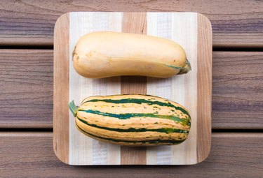 Delicata squash on a wooden surface