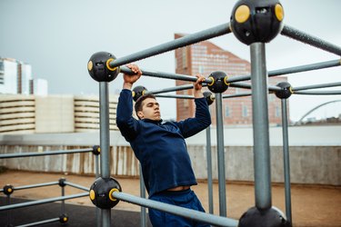 Man doing pull-ups outdoors as part of a CrossFit WOD