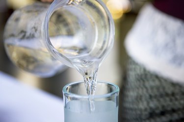 Pouring water into a glass