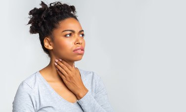 Upset woman having pain in her throat