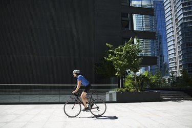 Woman riding bicycle in sunny city