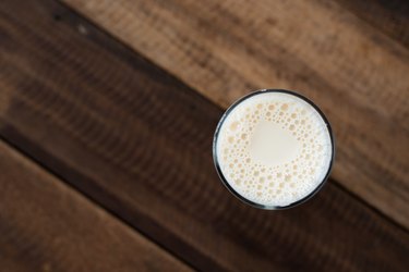 Close-Up Of Milk In Glass On Wooden Table