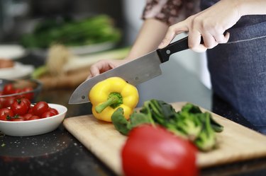 Woman cutting vegetables in kitchen