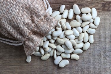 Beans in a bag on a wooden background