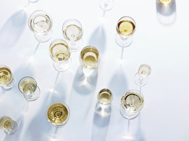 Wine glasses with white wine on white tablecloth