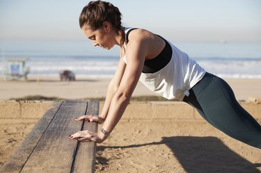 A Strong Girl With Big Muscular Arms On A Beach Stock Photo