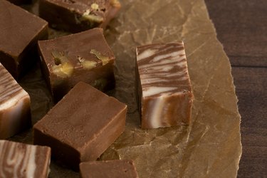 various flavors of hardened fudge on a wooden table
