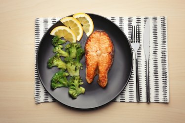 Low-carb roasted salmon steak with broccoli on plate for keto diet