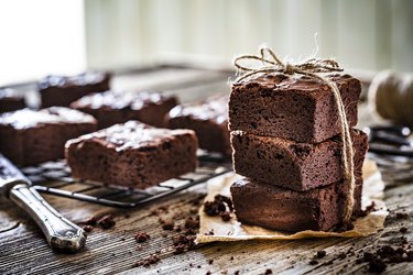 Homemade chocolate brownies shot on rustic wooden table
