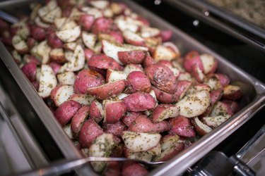 Metal tray of oven roasted potatoes