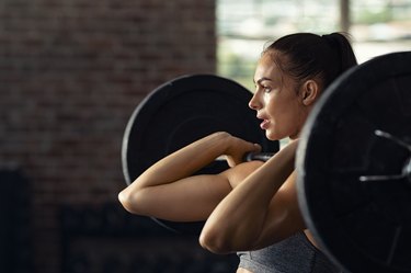 Woman doing weight lifting at cross fit gym